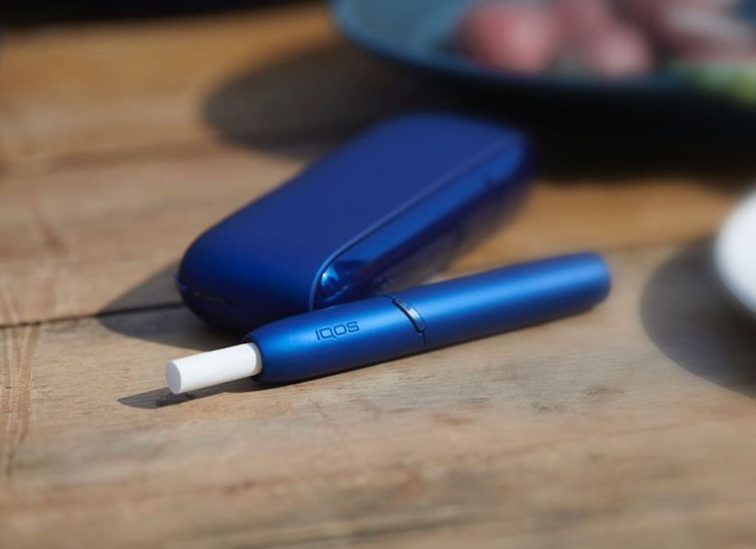 IQOS 3 next to coffee cups