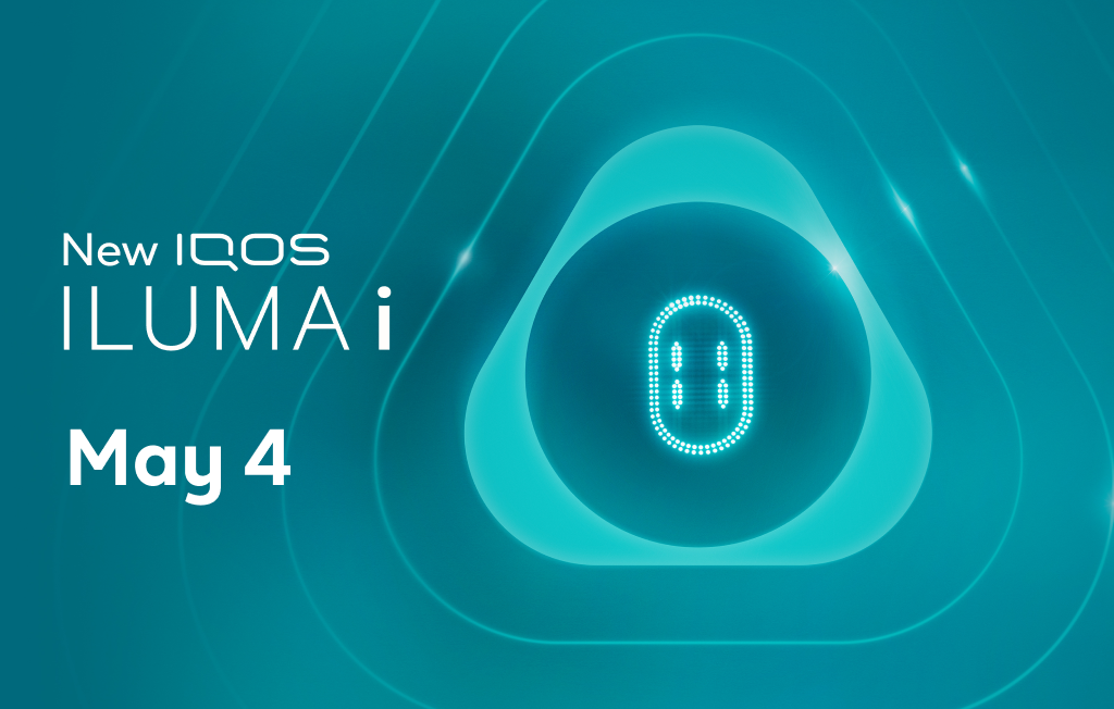 The IQOS ILUMA i touch screen lit up within the IQOS key on a teal background alongside the new IQOS ILUMA i logo and a May 4 launch date. ” tag.
