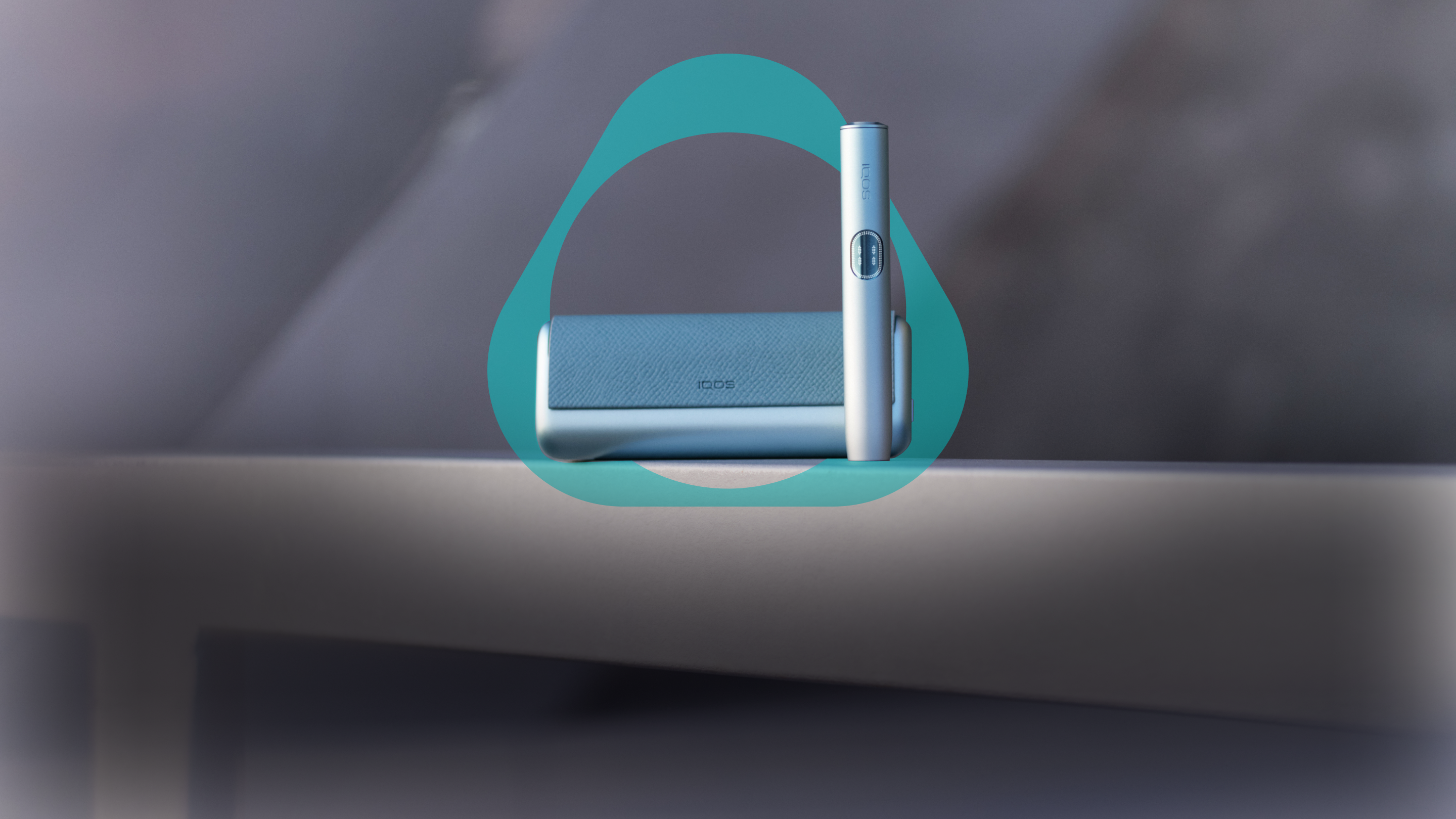 A Breeze Blue IQOS ILUMA I PRIME device placed inside an IQOS Key on a ledge.