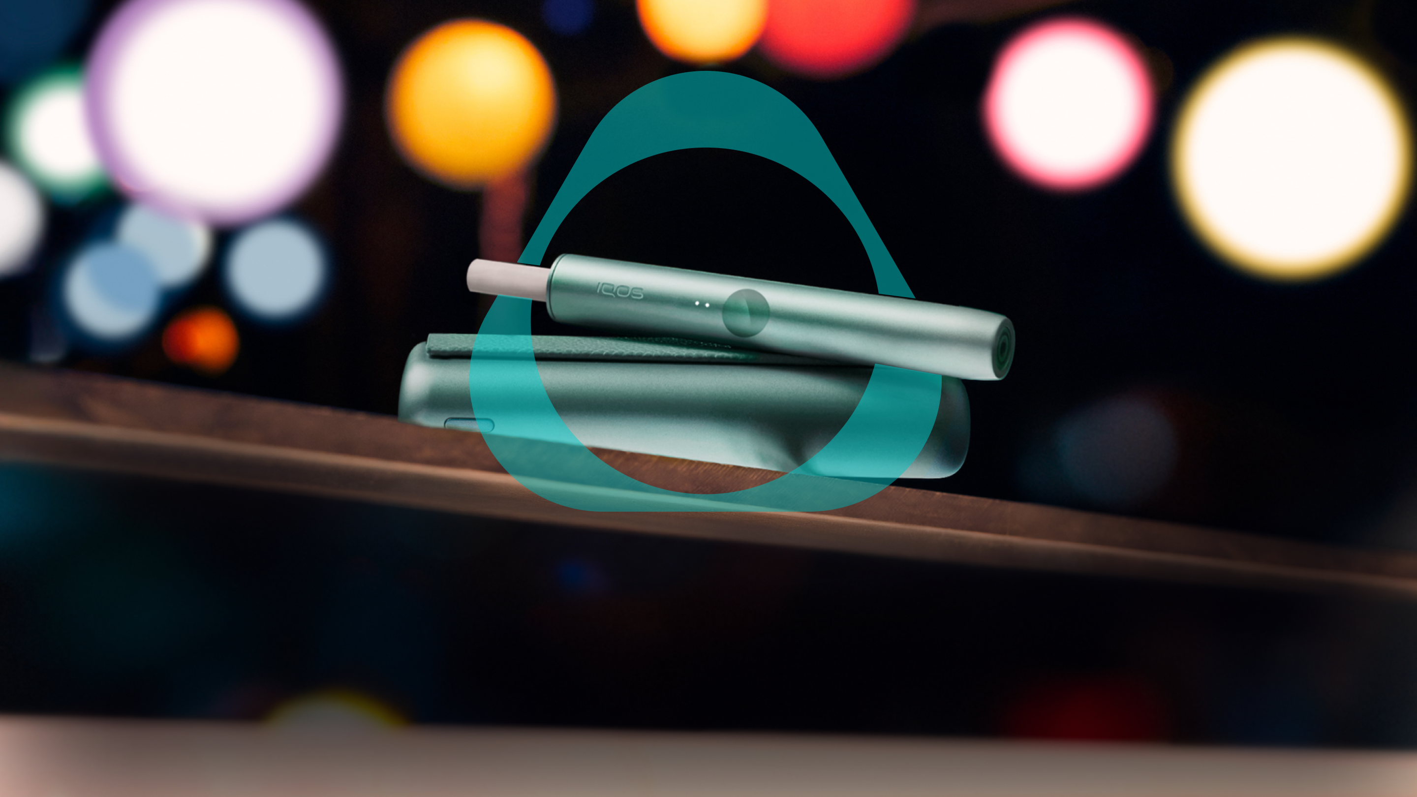 Sunset Red IQOS ILUMA device. Sunset Red IQOS ILUMA holder with Silvery Metal Ring. Pebble Grey IQOS ILUMA holder with Prisma Metal Ring.  