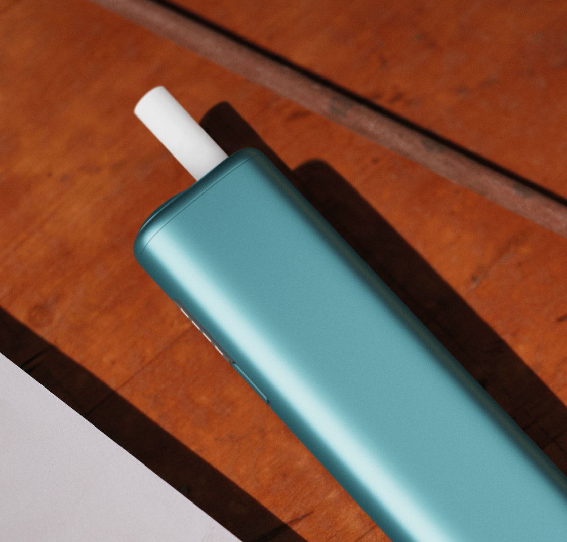 Breeze Blue IQOS ILUMA I ONE with a TEREA stick inside on a table.