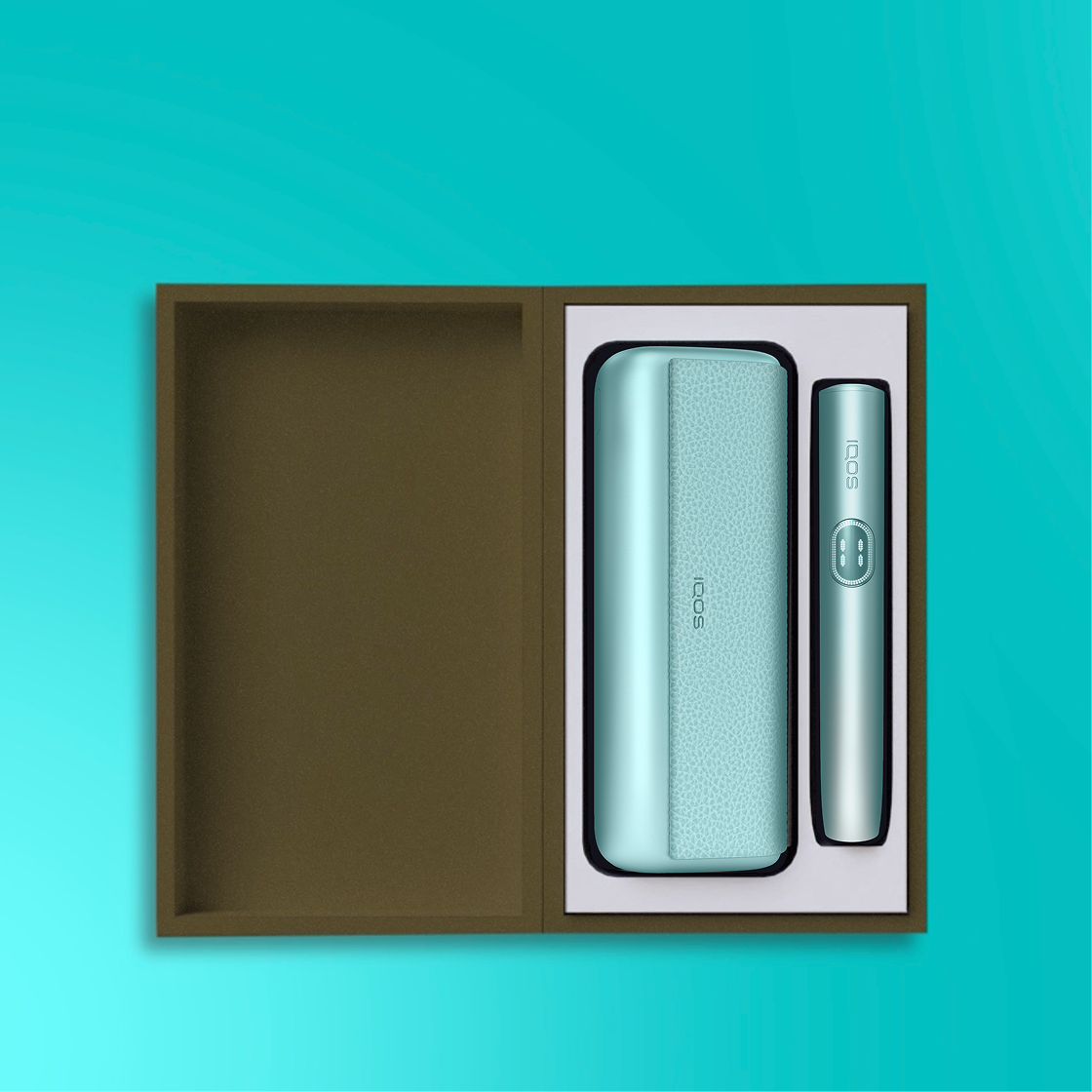 An IQOS ILUMA i PRIME Holder and Pocket Charger in a box.