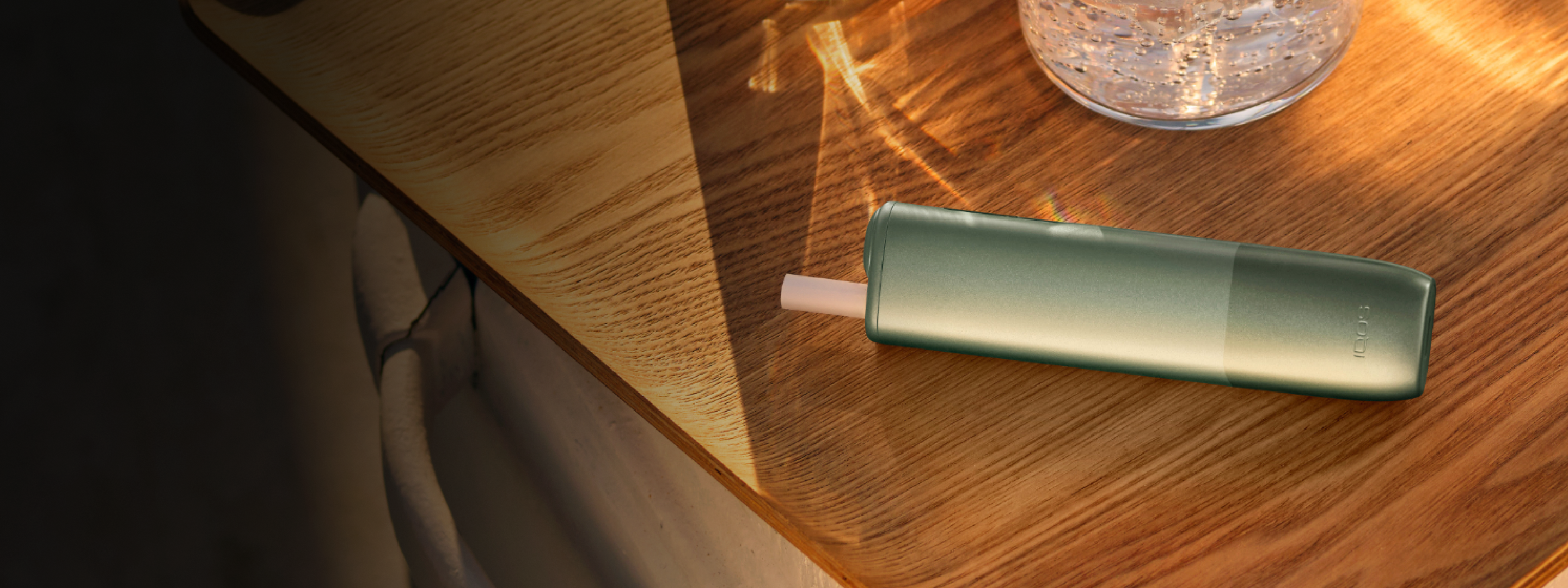 A Jade Green IQOS ILUMA PRIME Pocket Charger and Holder.
