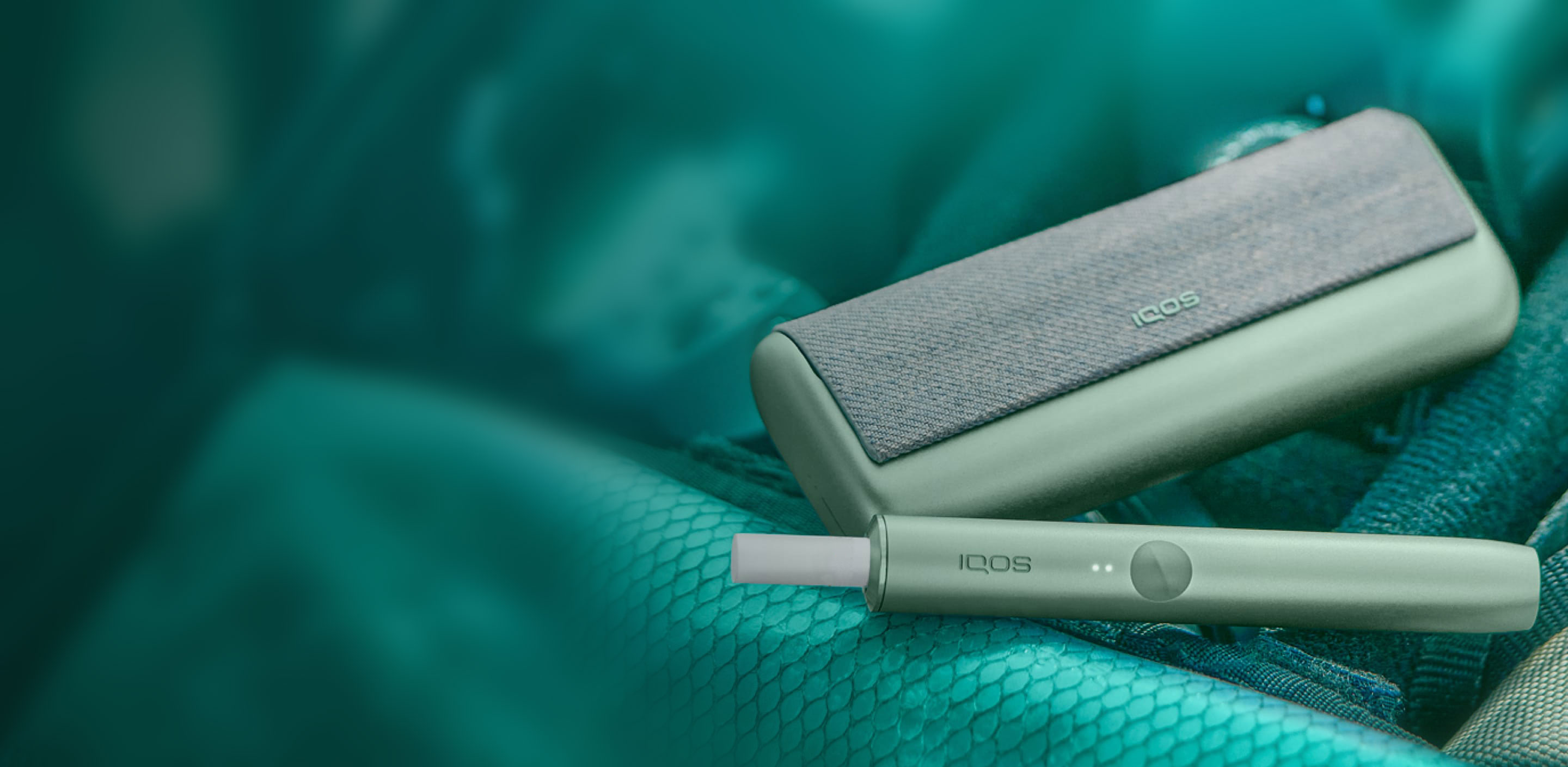 A jade green IQOS ILUMA PRIME Holder and Pocket Charger.