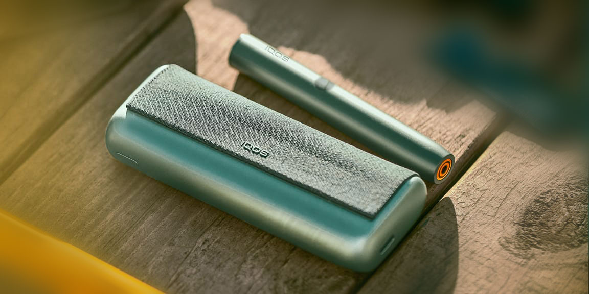 A jade green IQOS ILUMA PRIME Pocket Charger and Holder.