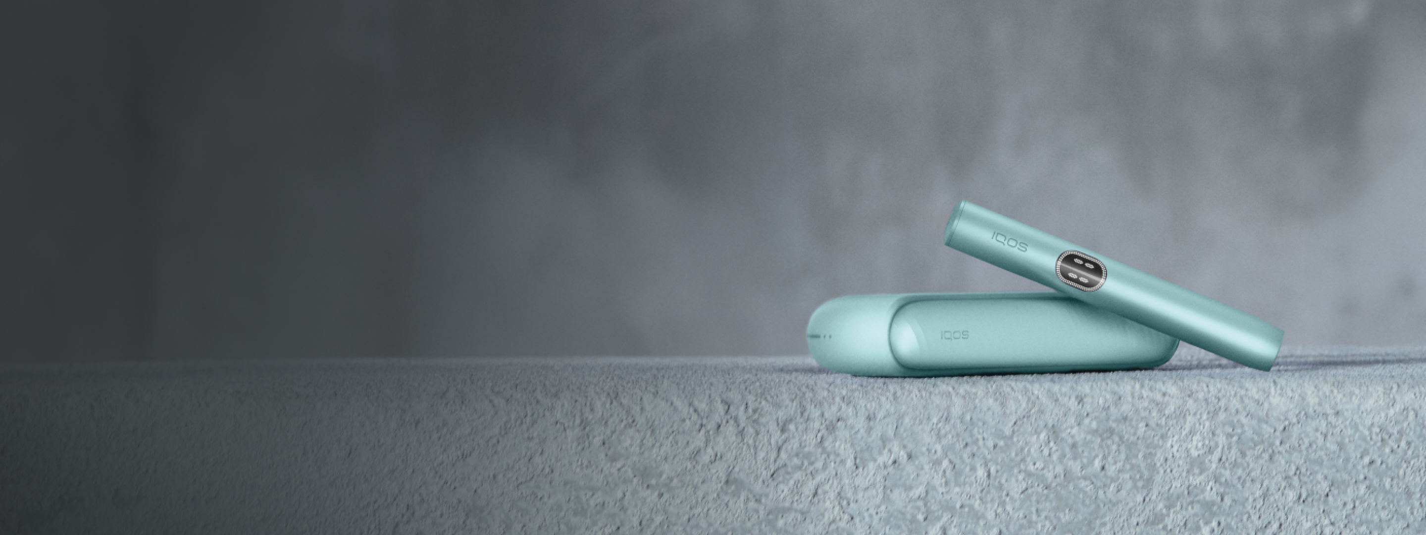 A Breeze Blue IQOS ILUMA i device on a ledge.