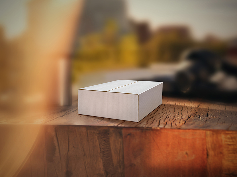 An unopened IQOS device box on a rug.