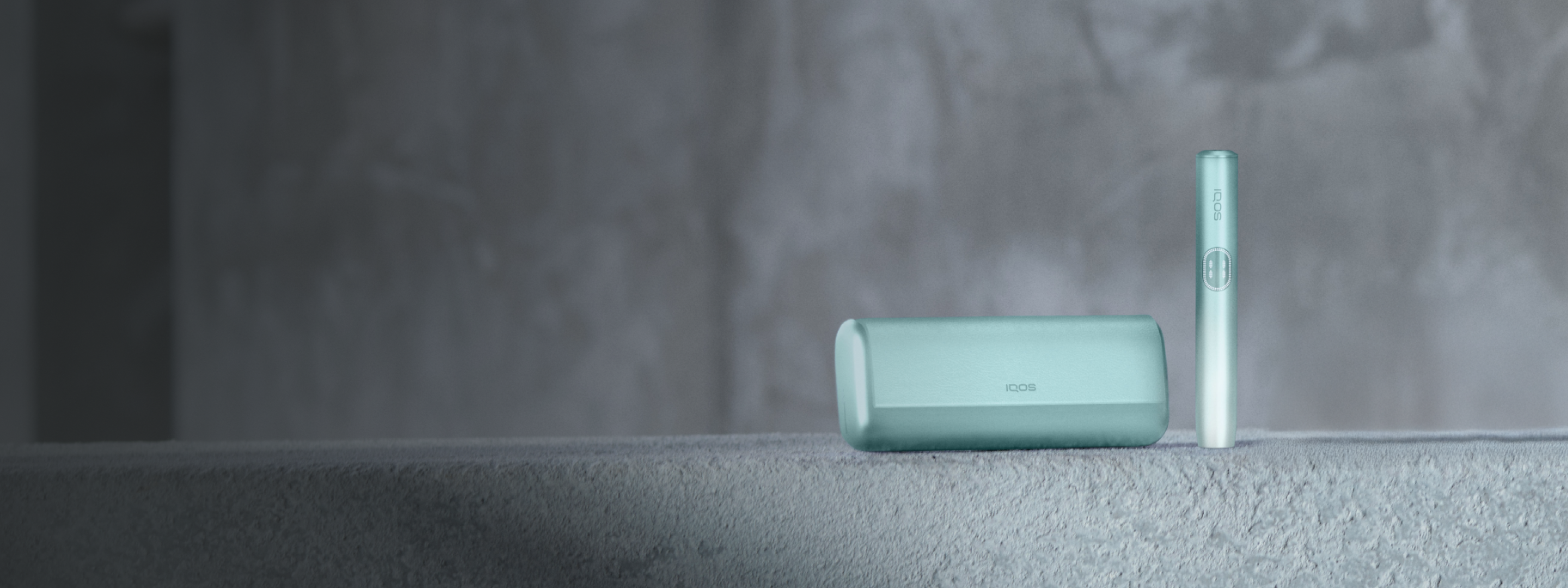 A Breeze Blue IQOS ILUMA i PRIME device on a ledge.