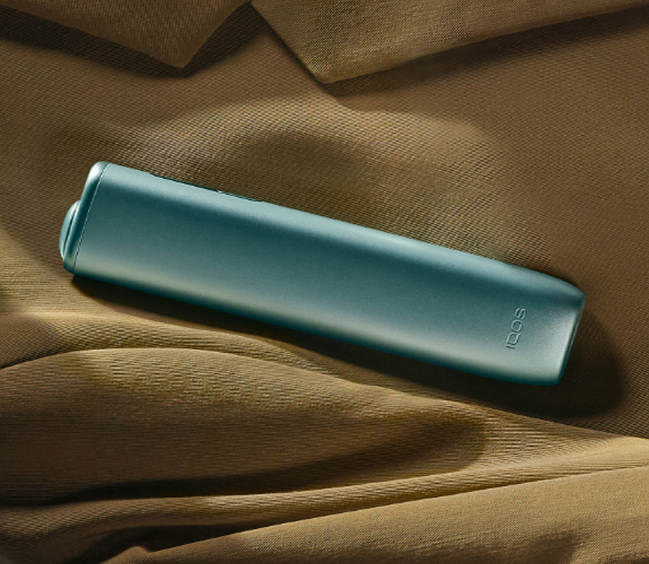An IQOS ILUMA device on a surface. 