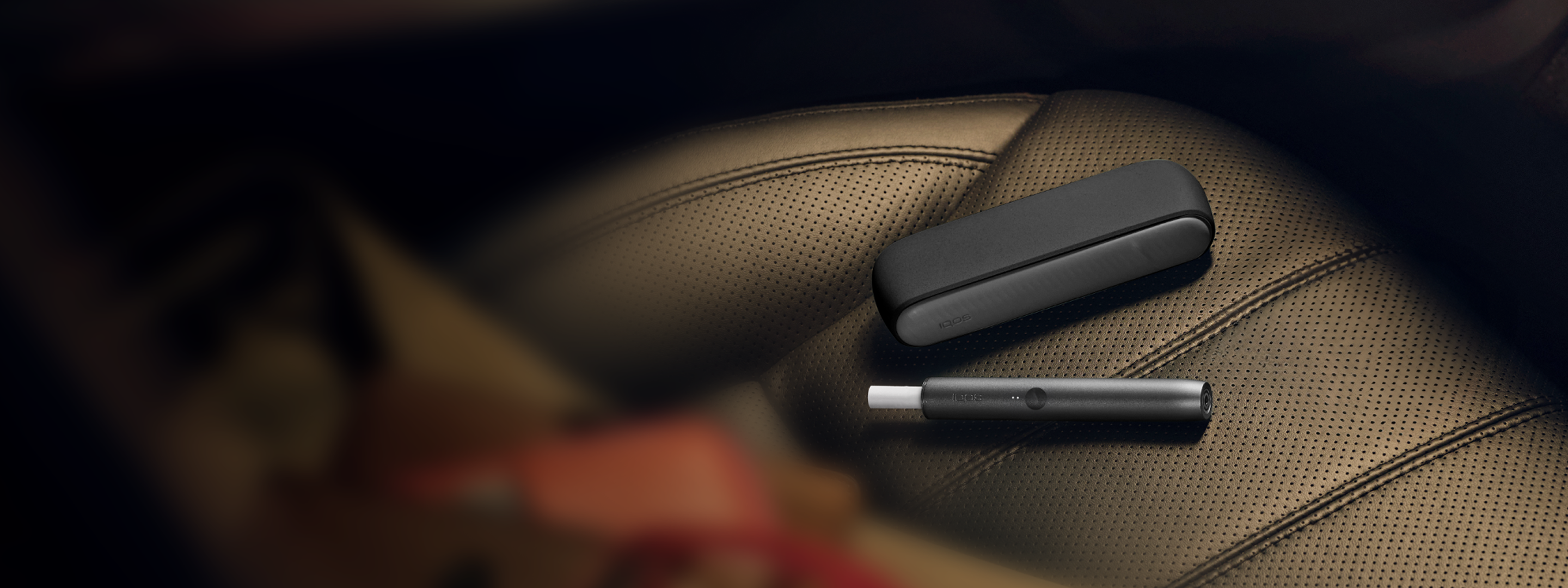 An IQOS ILUMA PRIME with a TEREA stick inside on a surface.