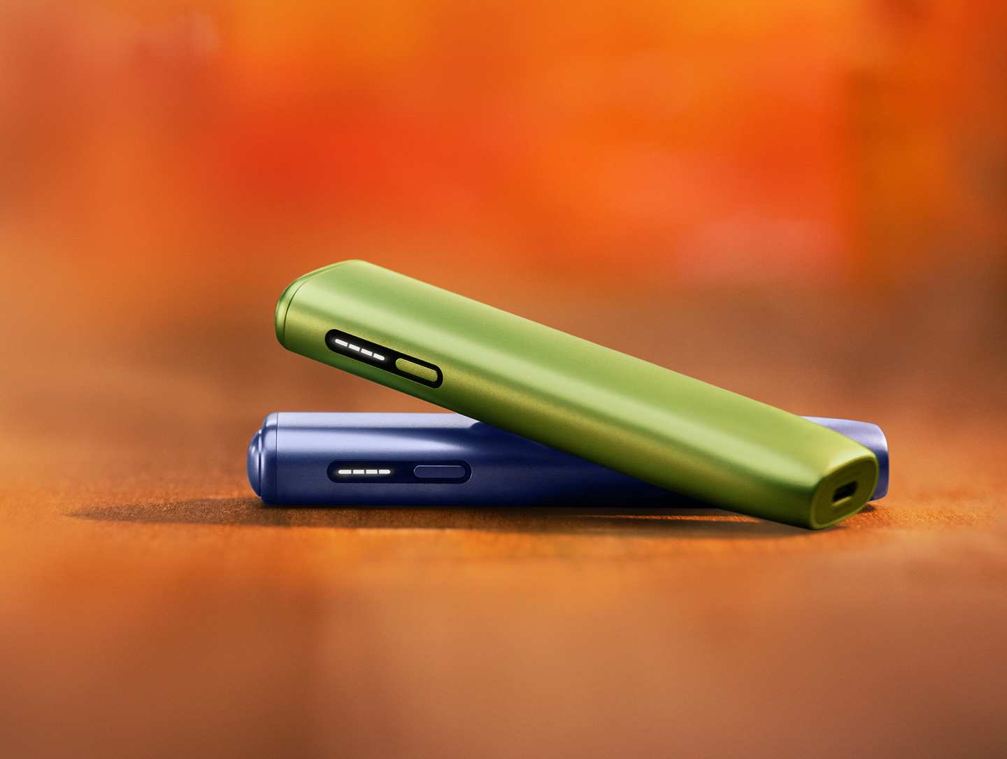 Two IQOS ILUMA ONE devices on top of each other. One of the devices has a TEREA stick inside. 