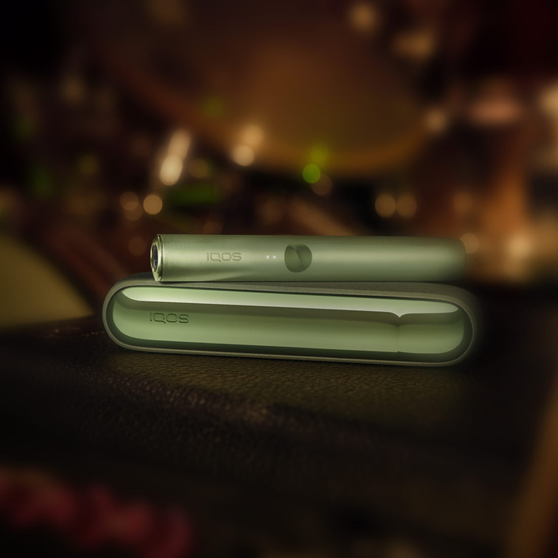 A Jade Green IQOS ILUMA PRIME Pocket Charger and Holder.