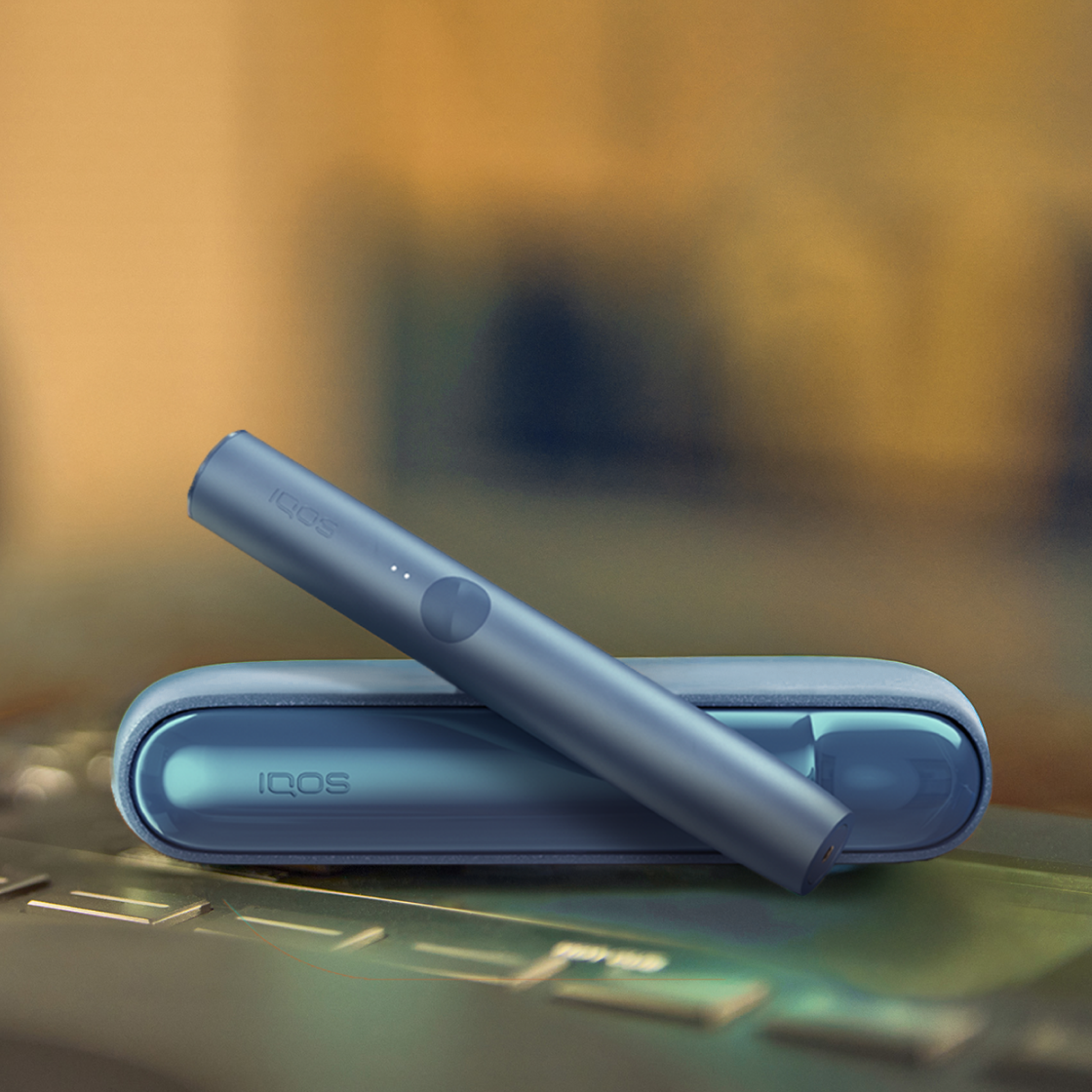 An IQOS ILUMA device on a table.