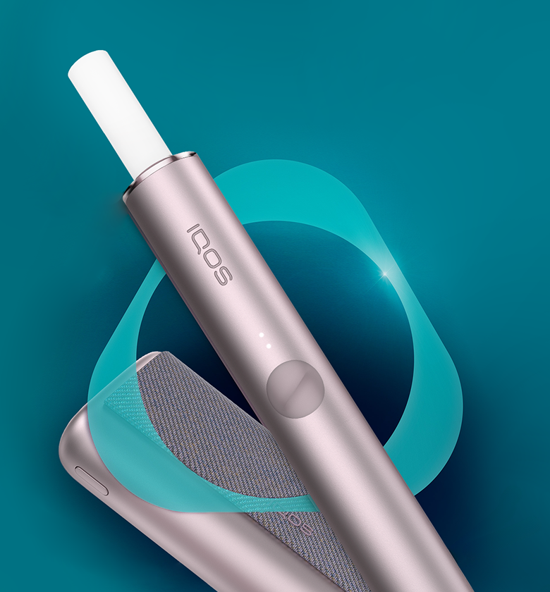 IQOS ILUMA PRIME device with a TEREA stick inside in front of the IQOS key.