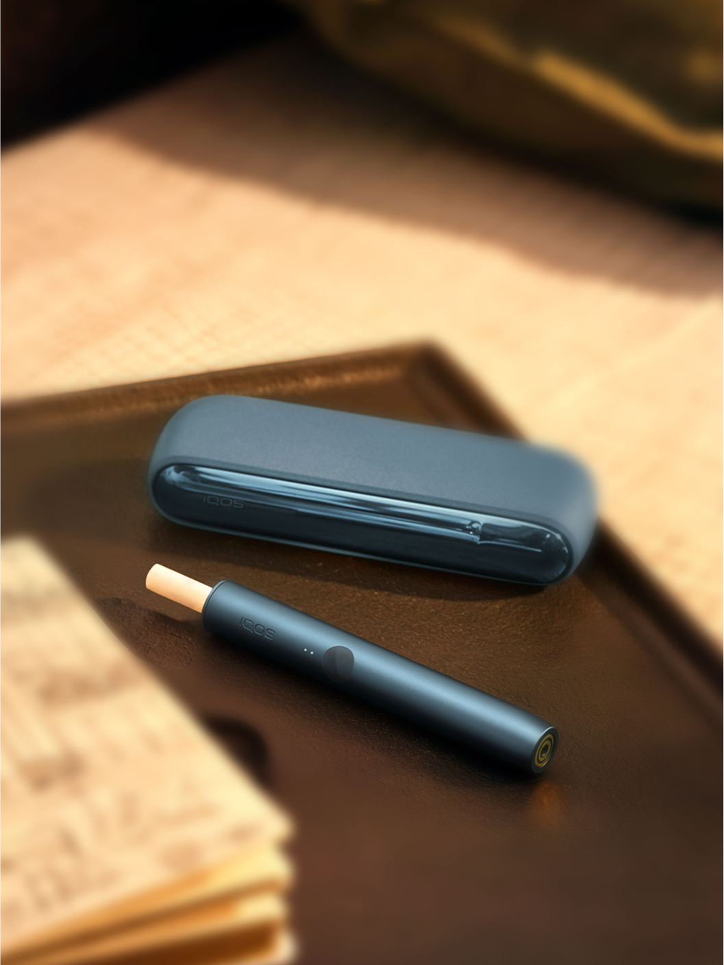 An IQOS ILUMA device on a tray.