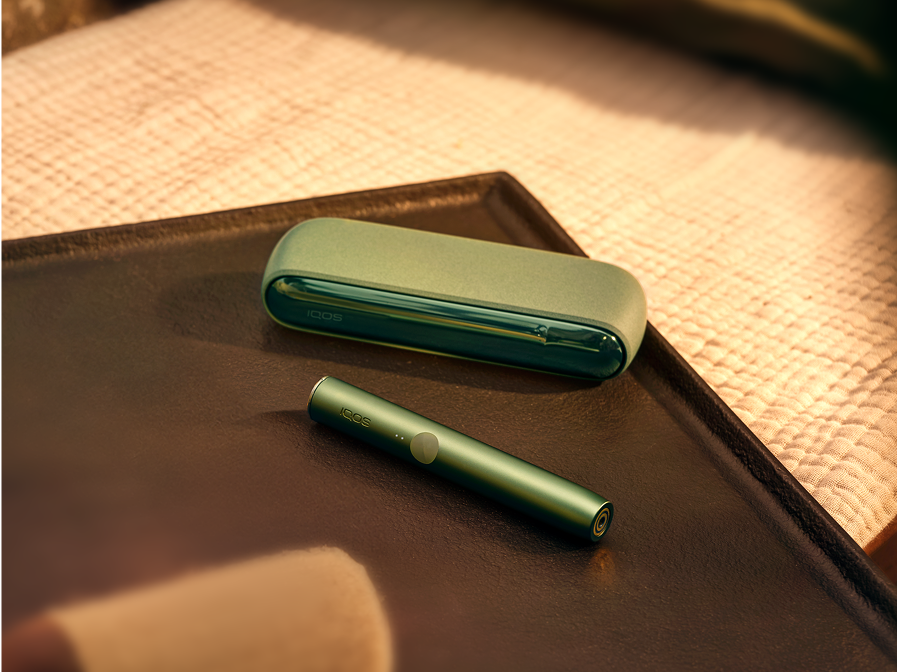 An IQOS ILUMA device with a TEREA stick inside on a tray.