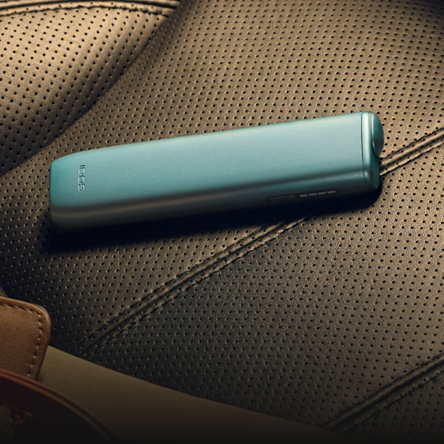 A Breeze Blue IQOS ILUMA I ONE  device on a seat.