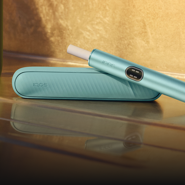 A Breeze Blue IQOS ILUMA i device with a TEREA stick inserted on the floor.