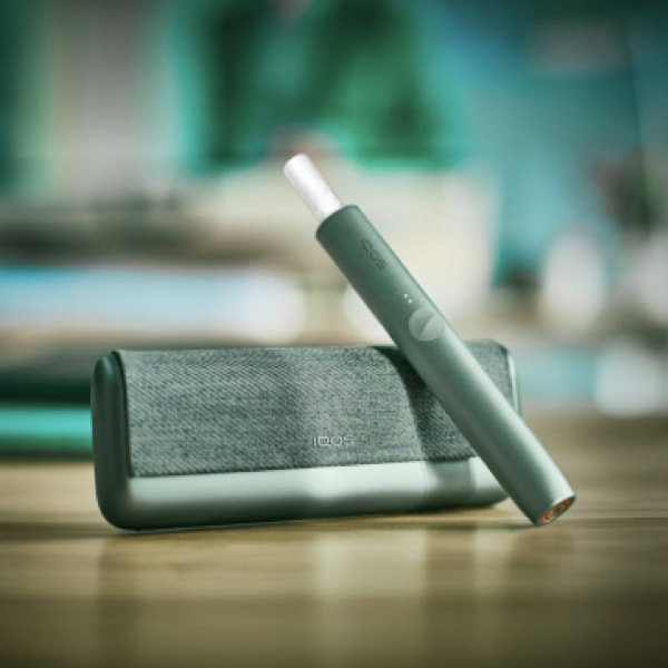 A Jade Green IQOS ILUMA PRIME Holder and Charger.
