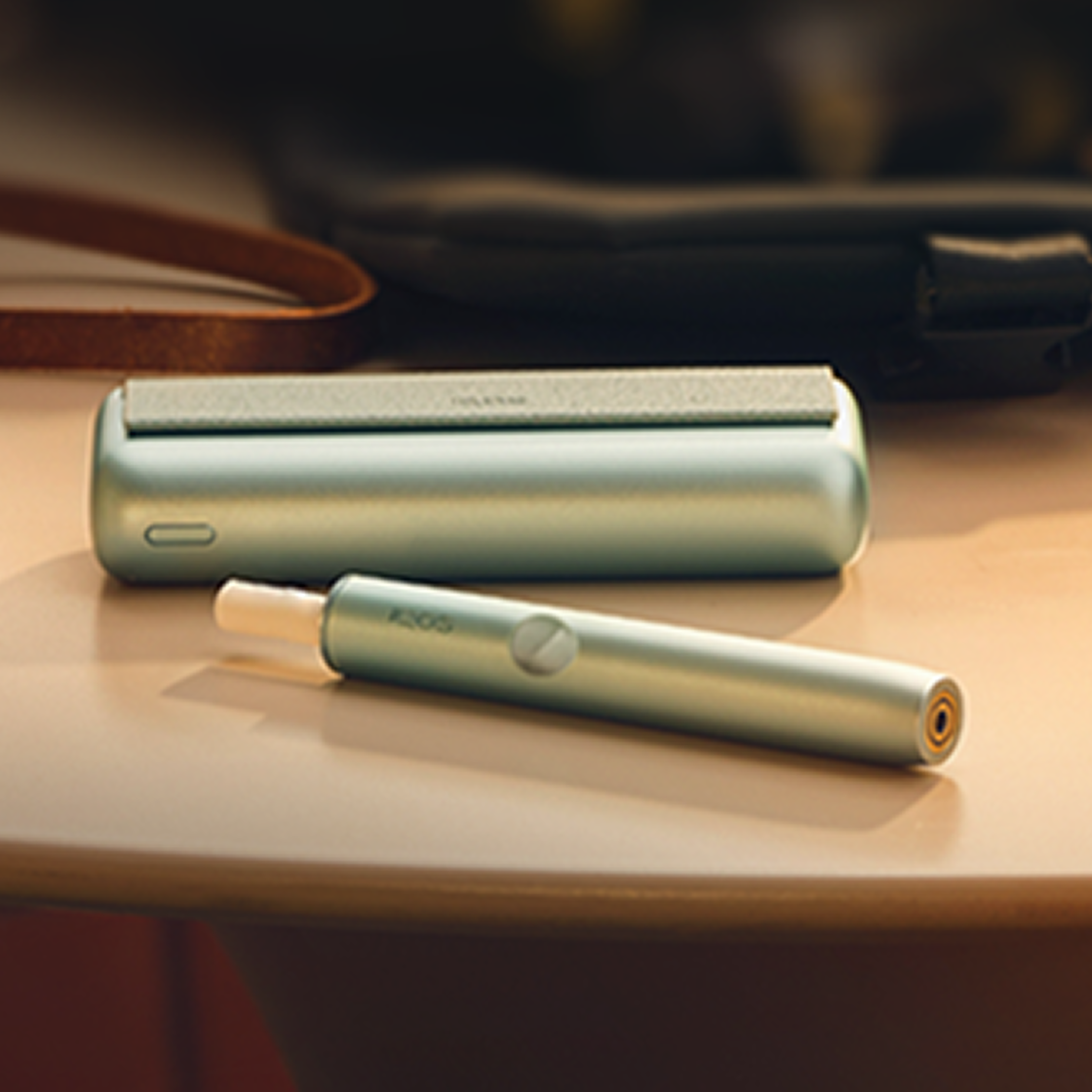 A Jade Green IQOS ILUMA PRIME Holder and Charger.