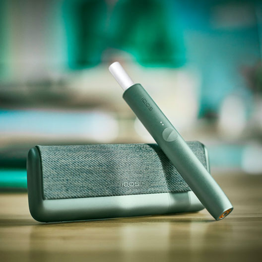 A Jade Green IQOS ILUMA PRIME Holder and Pocket Charger.