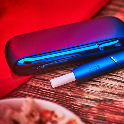 Stellar blue IQOS 3 DUO with HEETS stick on table